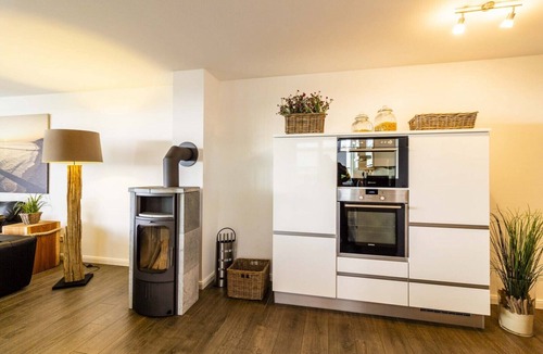 Grossenbrode Apartment | Dream Vacation Rental: Ostseeresidenz 2 in Großenbrode. Cozy wooden deck. Exclusive beer dispenser and an idyllic garden with a beach chair. Pure Wellness with a Sauna & Wellness Shower