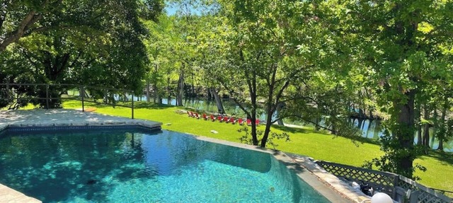 Inviting waterfront home with pool, patio, fireplace, W/D, & dog-friendly in Hunt